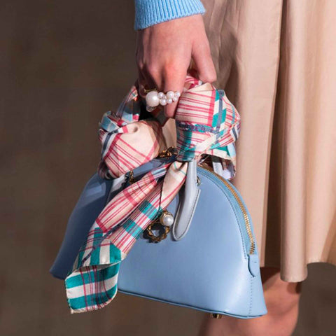 A way to wear your headscarf is on a bag