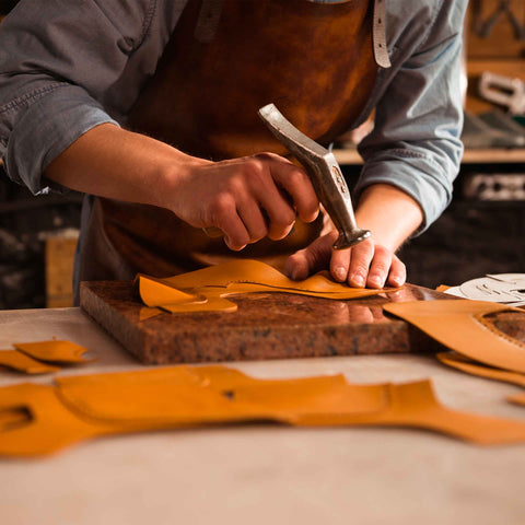 man working with natural leather for italian manufacturing - Design Italy