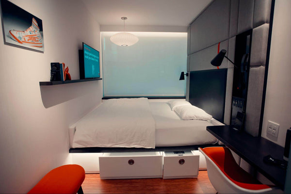 a modern, well-lit bedroom with contemporary furniture and decor.