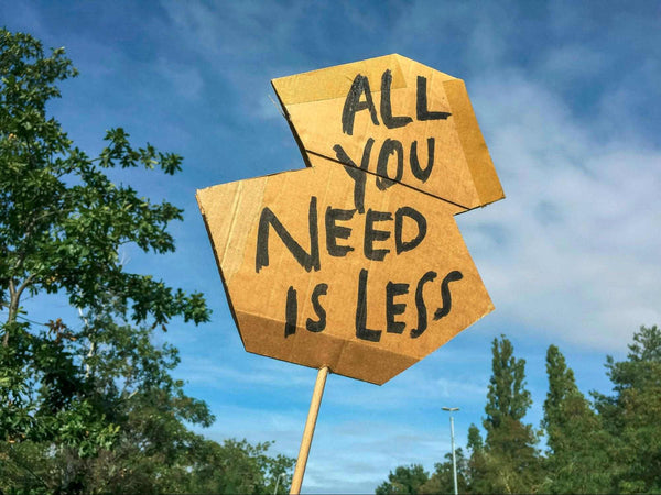 Road sign that says all you need is less