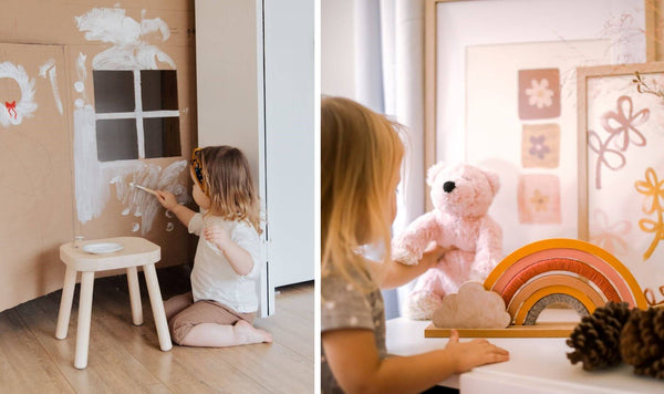 Little girl painting her cardboard house