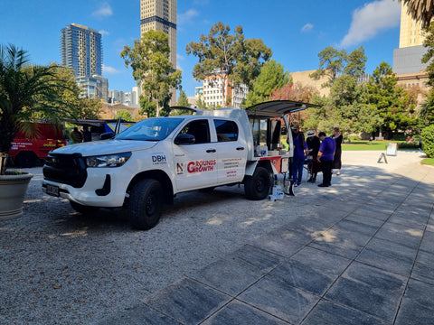 Novita's coffee van in Government House garden with people selling coffee from the rear