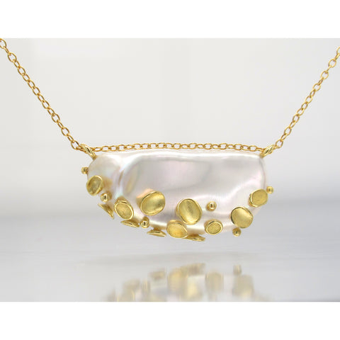 Shell pendant necklace in 18k yellow gold with a flattish white baroque freshwater pearl, $2,800; Barbara Heinrich; email info@barbaraheinrichstudio.com for purchase