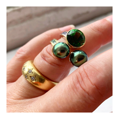 Ring in 18k white and yellow gold with a 3.81 ct. green tourmaline and two 2–8 mm cultured Tahitian pearls with 1.52 cts. t.w. sapphires and 0.40 ct. t.w. tsavorite garnets by Lara Alexander of FWM Jewelry