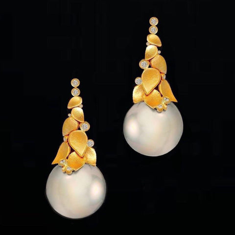 Leaf earrings in 18k yellow gold with 13 mm white Sea Pearls and 0.50 cts. t.w. diamonds by Enrique Garcia of R & E Garcia Inc.