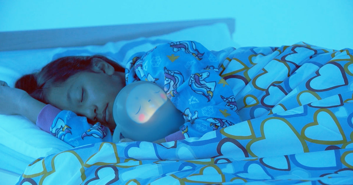 Child sleeping in bed with Snorble®.
