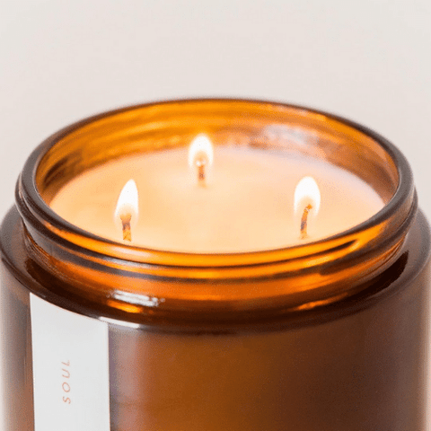 How To Make A Candle Last Longer- Image of a burning triple wicked soy wax candle
