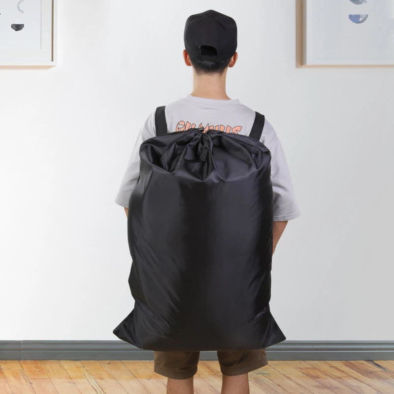 Person carrying a high-capacity laundry backpack with adjustable shoulder straps in black, ideal for easy transport of large loads