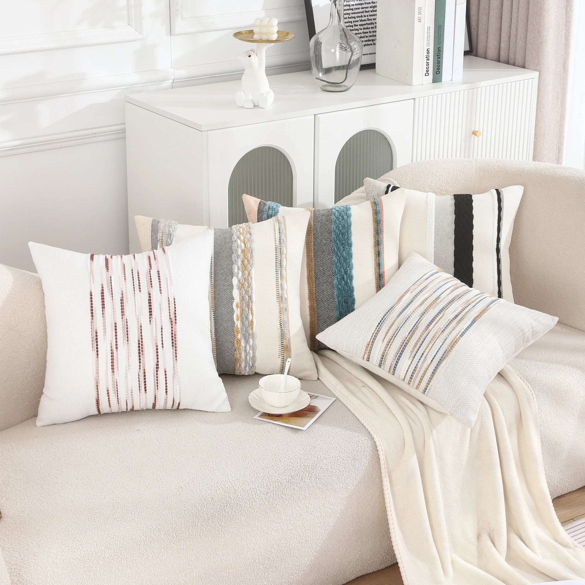  Embroidered Chenille Striped Pillow Throw Covers arranged on a beige sofa, showcase intricate chenille embroidery in various striped patterns and colors, adding a touch of sophistication and comfort to the space