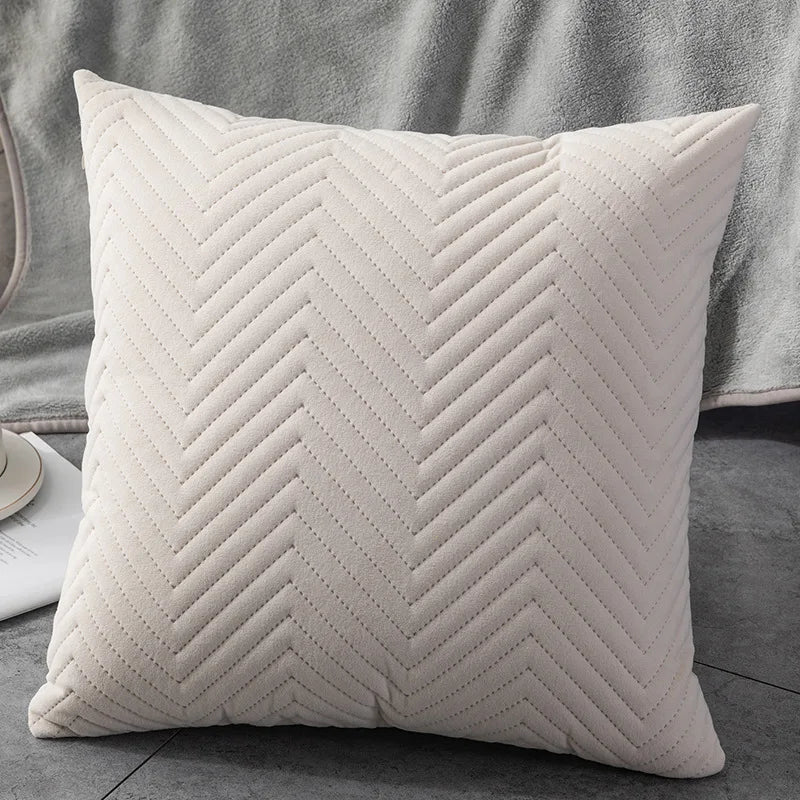 Close-up of a beige white  throw pillow featuring a crisp chevron pattern, showcasing its textured and stylish design 44564829667491
