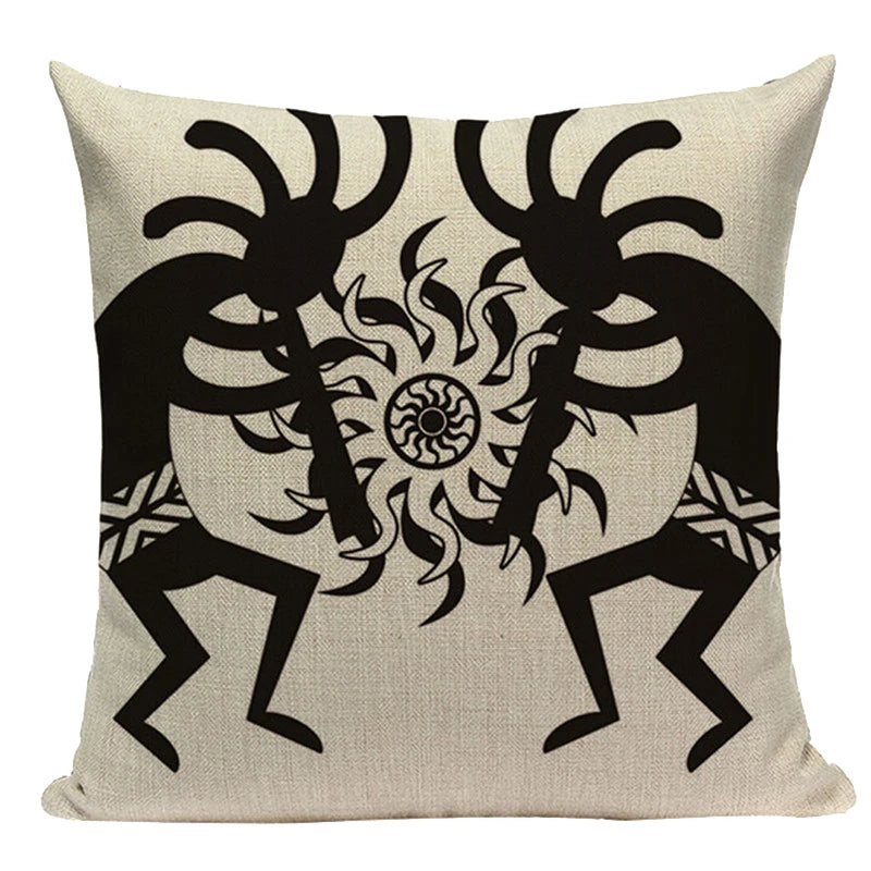 White throw pillow with a black illustration of two traditional figures facing each other, holding a sun-like symbol between them. 44555431510179