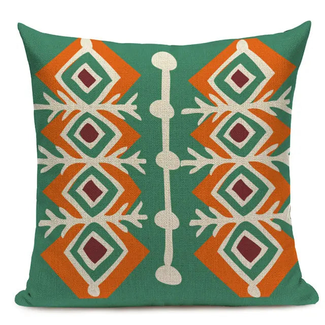 Green throw pillow with an intricate orange, white, and burgundy diamond-shaped pattern, inspired by traditional designs 44555430953123