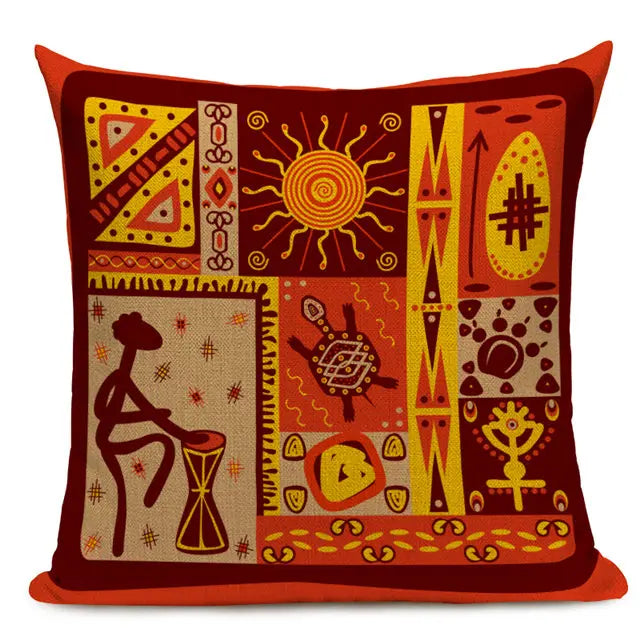Red and orange throw pillow featuring a patchwork of traditional African-inspired designs, including a drum player, sun, and various symbolic patterns. 44555431575715