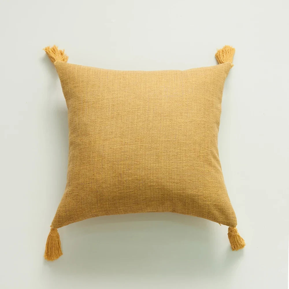  Mustard color  woven handmade cotton throw pillow cover with tassels at each corner, displayed against a white background. 44583666385059