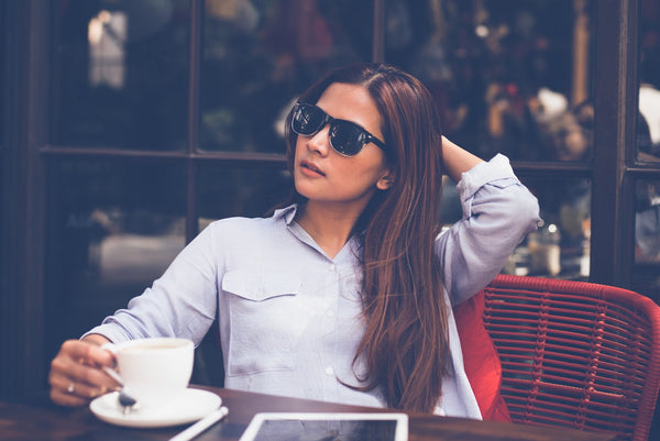 serious young woman having coffee