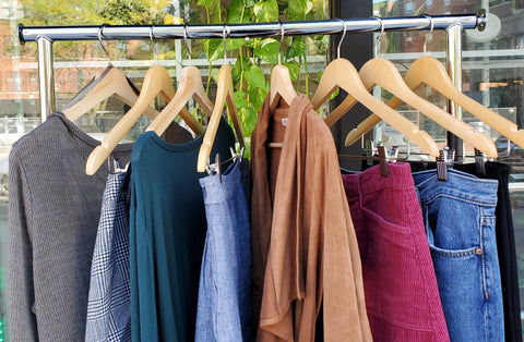 Second hand clothing hanging on a clothing rack outside of Uvida Shop during one of our seasonal clothing swaps.