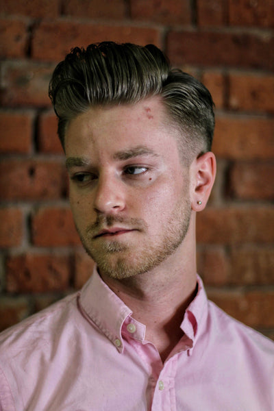 Portrait of young man with retro classic pompadour hairstyle. studio shot.  looking at camera Stock Photo - Alamy