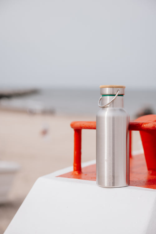 Blockhuette Vacuum Insulated Stainless Steel Water Bottle at the beach