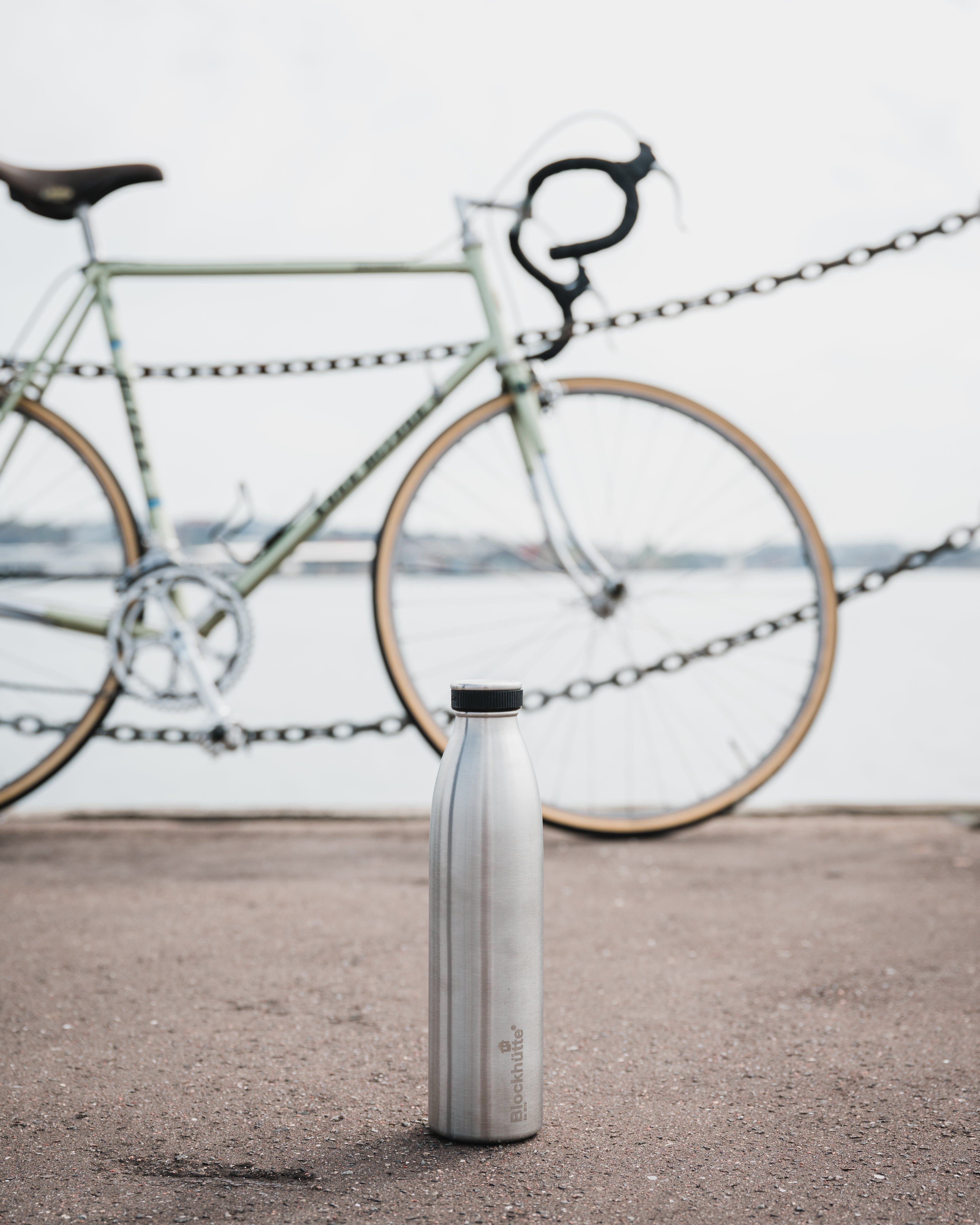 Blockhuette double vacuum insulated stainless steel water bottle in front of a bike