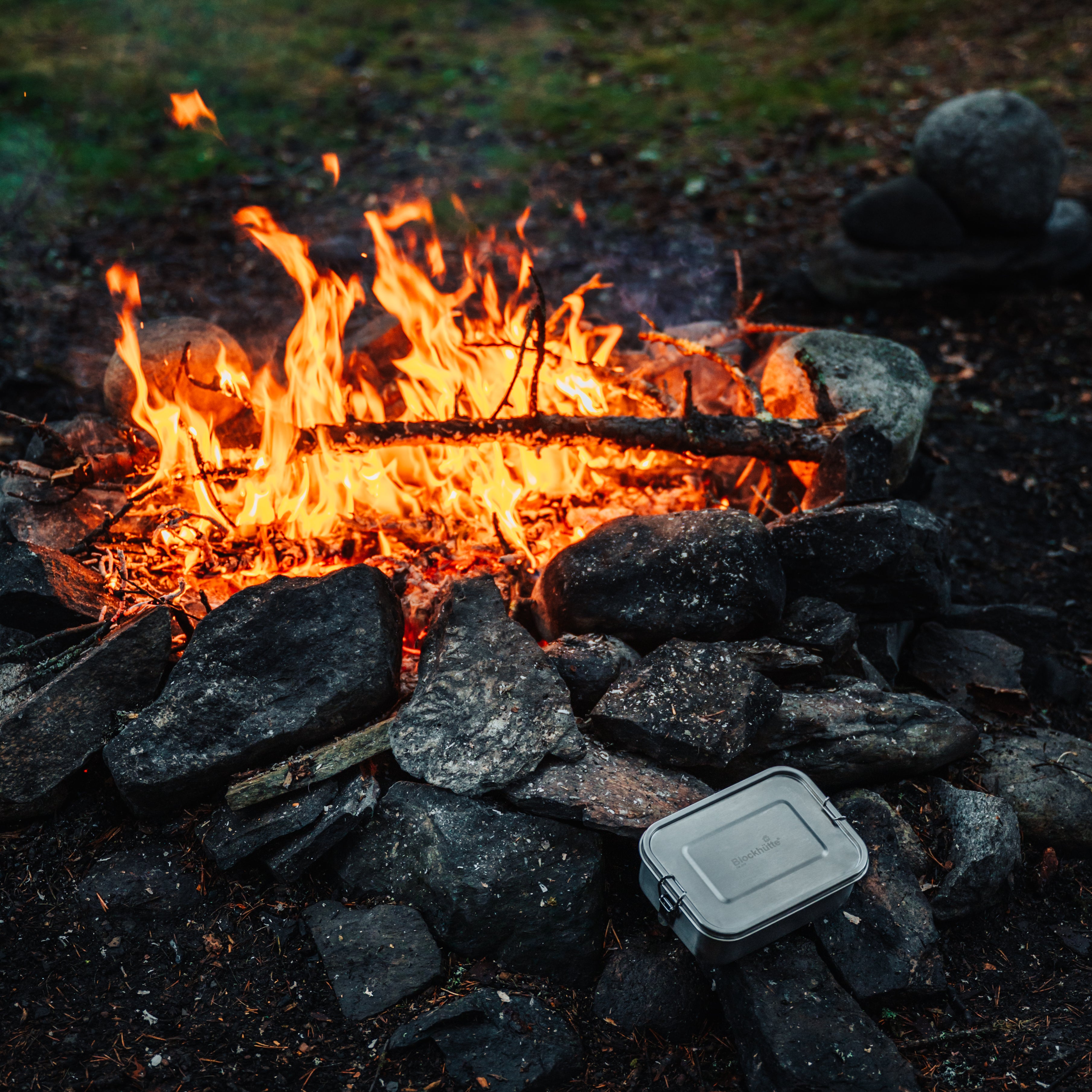 Blockhuette stainless steel lunch box infront of a bonfire