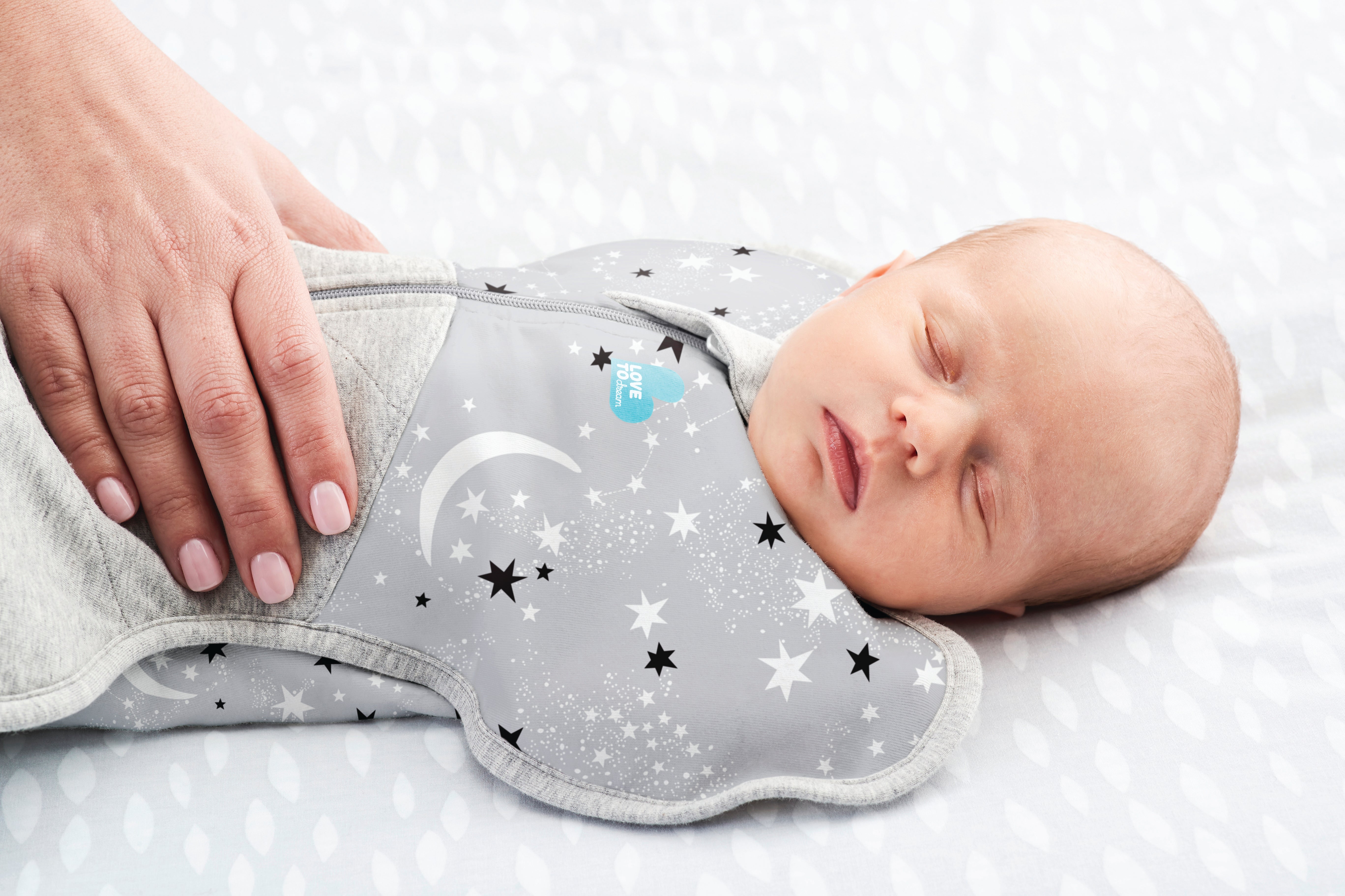 Sleeping baby soothed in Love to Dream swaddle.