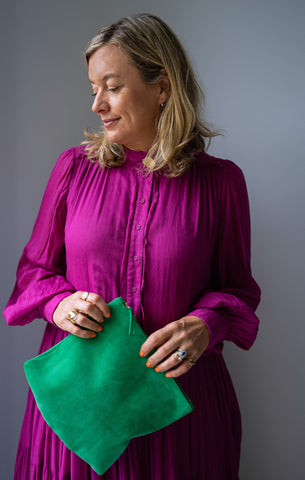 green suede clutch with pink outfit