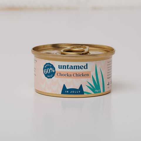 A close-up of a white and pastel pink can of Untamed’s Chocka Chicken in Jelly