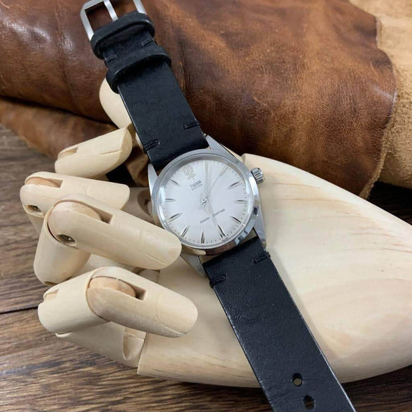 Vintage Nero leather strap on a classic Tudor Oyster watch: "Vintage charm meets modern elegance: the rich black hue of the Vintage Nero leather strap complements the iconic lines of the classic Tudor Oyster watch