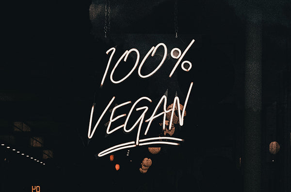 A neon sign which reads '100% vegan'