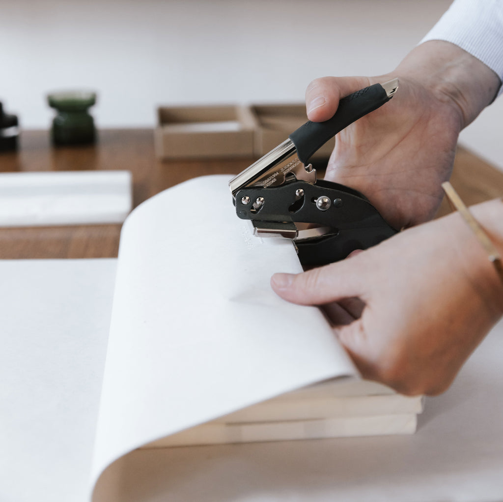 Hand-embossing sheets of wrapping tissue