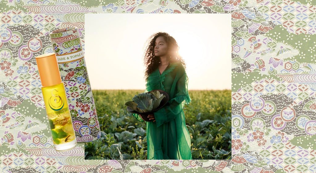 image of jade and topaz blend with crystals infront of woman wearing a green dress in a field .