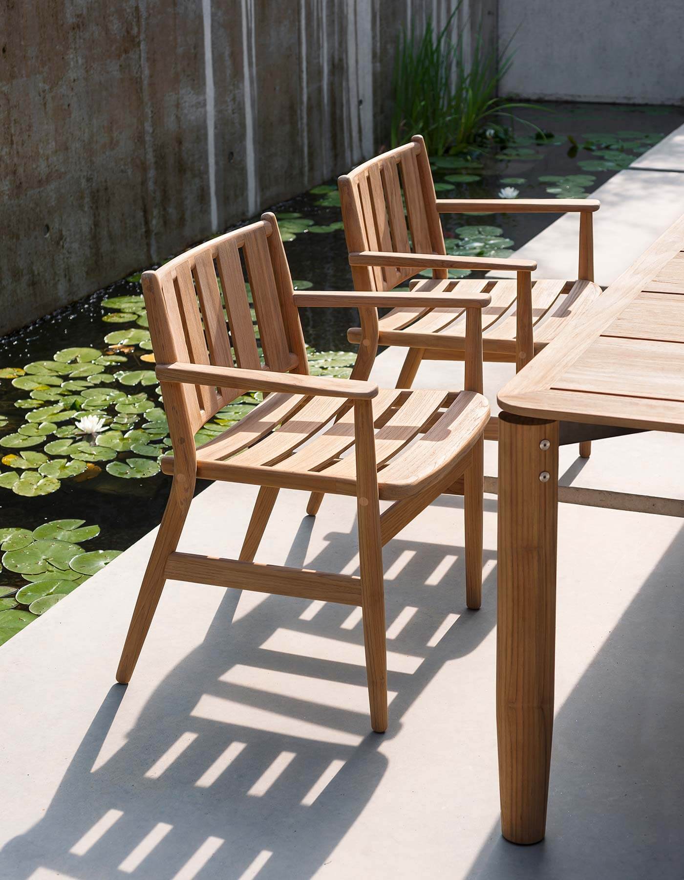 Teak table and armchairs, part of RODA’s LEVANTE dining collection.