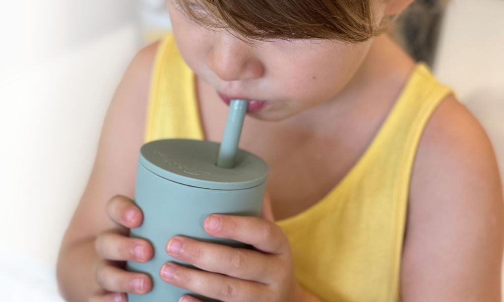 Toddler Girl drinking from a Kids Straw Cup