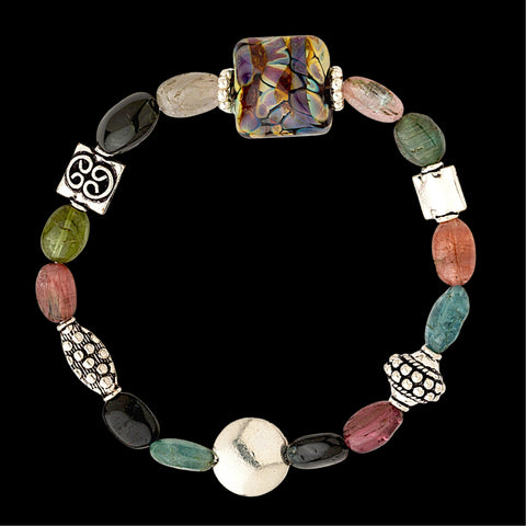 Celebrate Gemstone Bracelet hand-sculpted glass bead enhanced with sterling silver beads and tourmaline gemstones on a stretchy nylon cord 