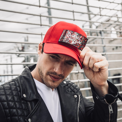 Man with red fashion trucker hat and the removable Art Partch-clip do what you love