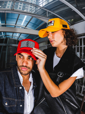 Man and Woman wearing a trucker hat by Partch fashion 