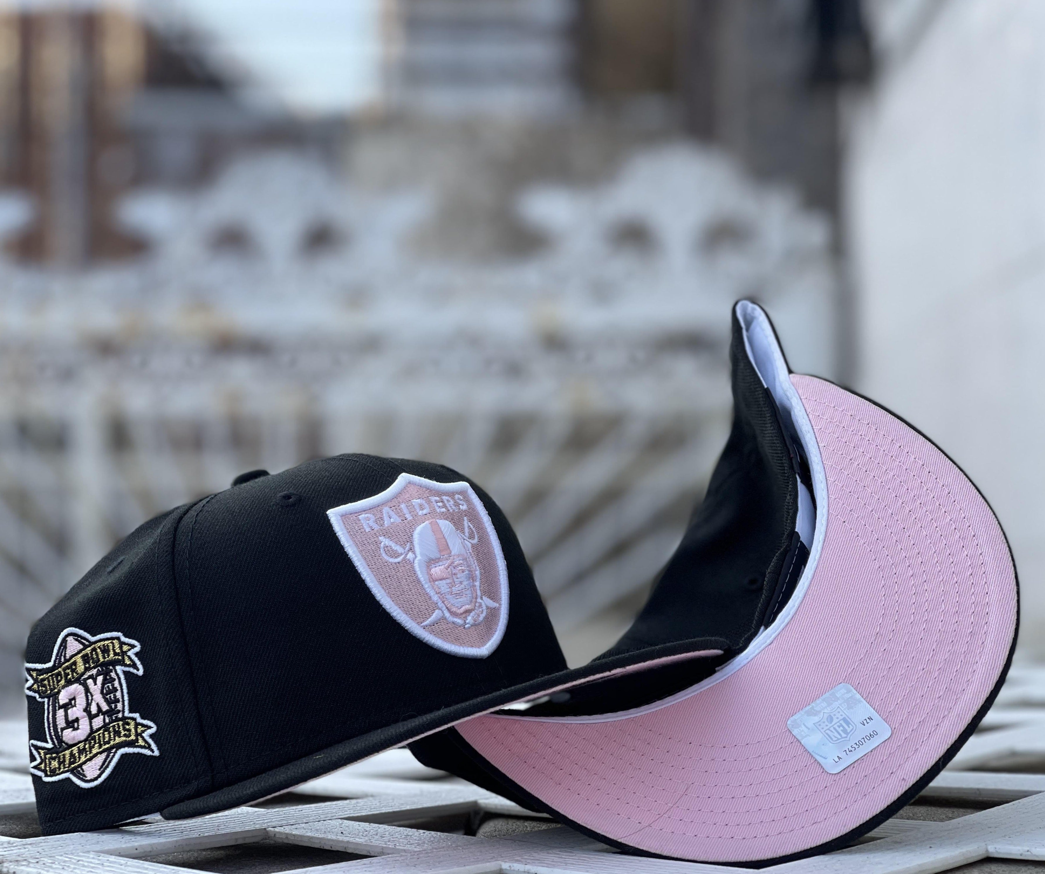 black and pink raiders hat