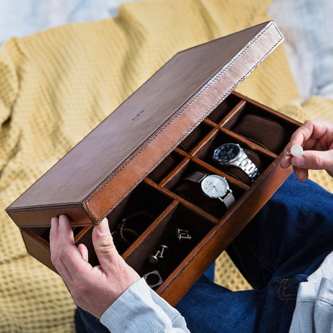 leather jewellery and watch box open with man removing cufflinks