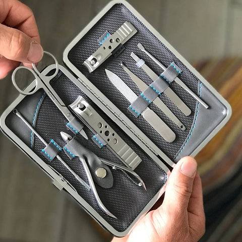 grey manicure set opened by a man pulling out scissors