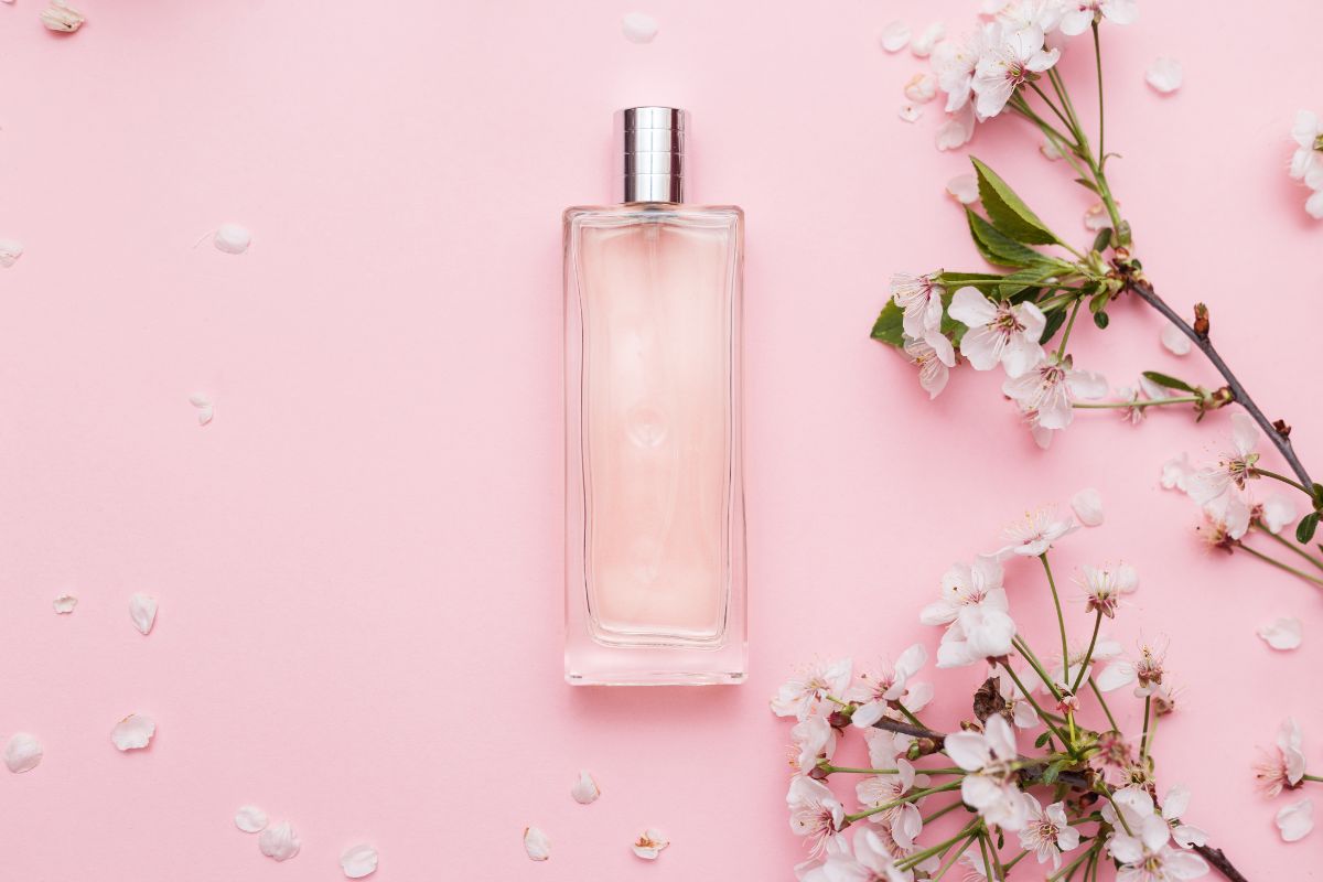 Floral perfume surrounded by flowers.