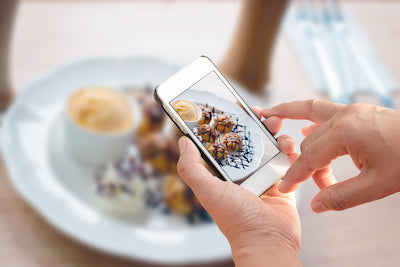 Taking photo of dish at restaurant