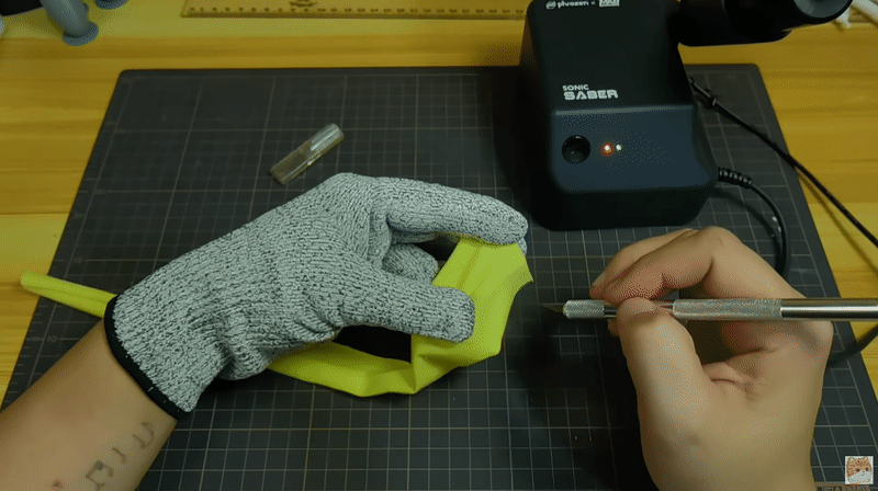 Using Sonic Saber to cut a piece of fabric