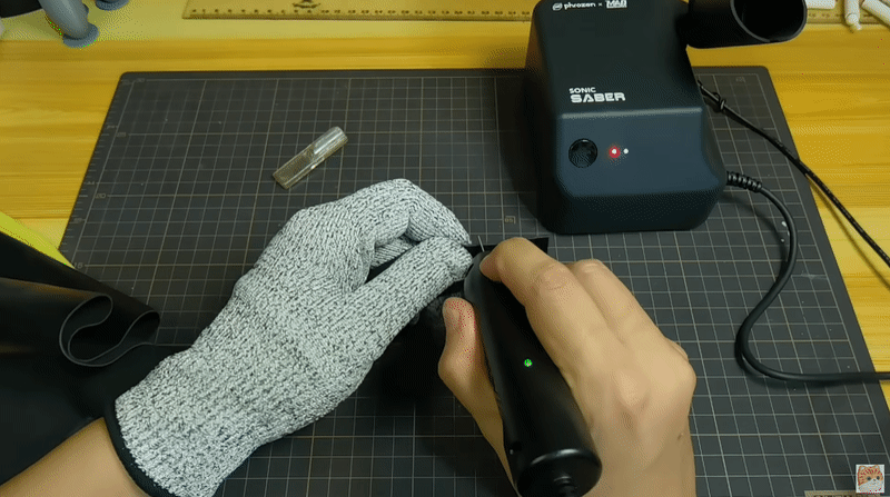Using Sonic Saber to cut a piece of leather