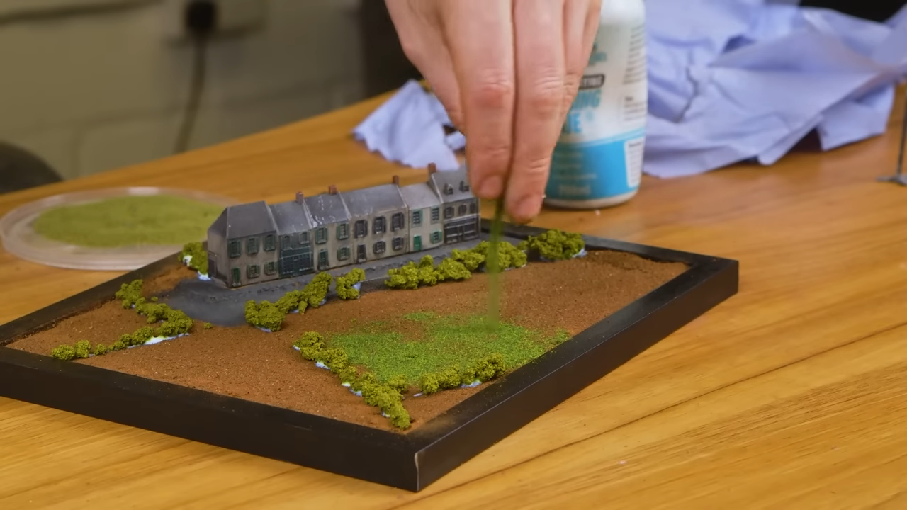 Adding bushes and grass to his diorama models