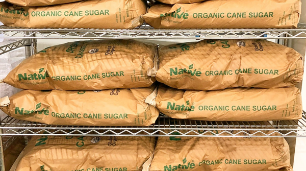 bags of cane sugar stacked on shelves