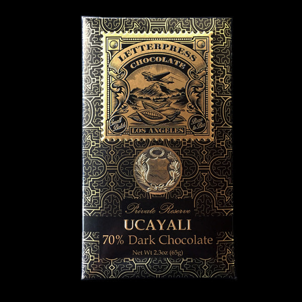 a front view of the black and gold ucayali packaging on a black background