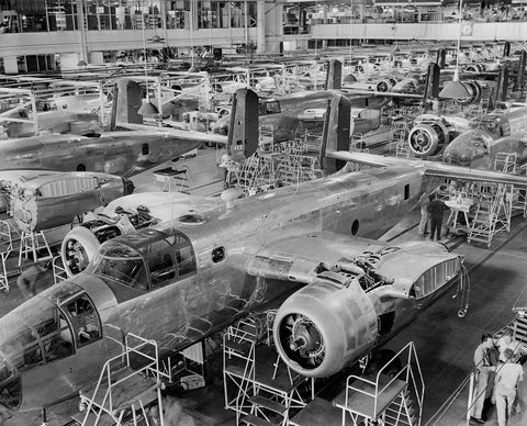 A black and white image featuring rows and rows of B-25 aircraft in assembly