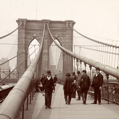 A sepia toned image of people walking on the Brooklyn Bridge Promenade