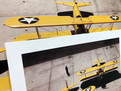 A close up photo of the texture of paper and canvas prints of a vintage airplane photograph