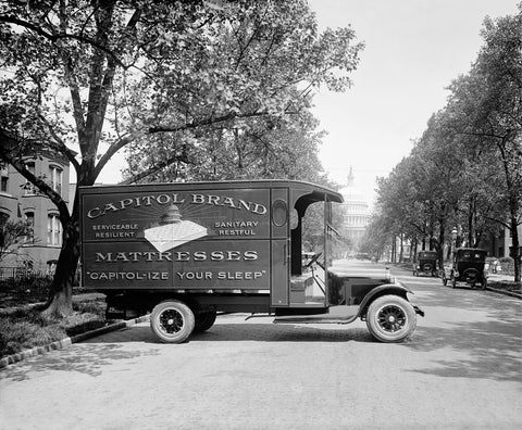 Black and white vintage photograph of a Ford Capitol Bedding Truck